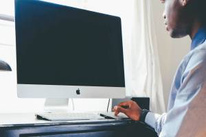 black doctor working on computer