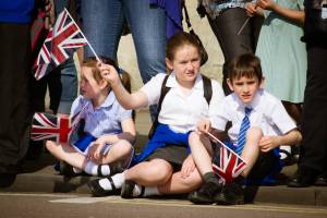 young kids watching a parade in the UK