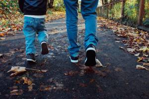 dad and son walking along a trail