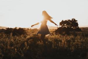 young girl happy in a field