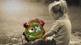young girl fixing her stuffed animal