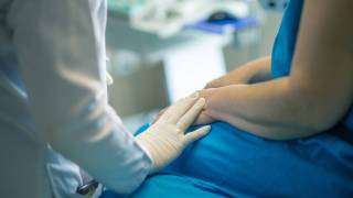 woman being talked to by a doctor in a clincial trial