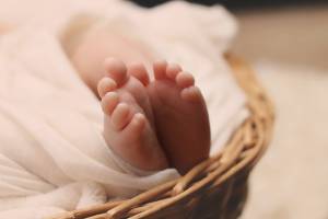 new born baby feet in a basket