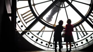 women looking at a clock
