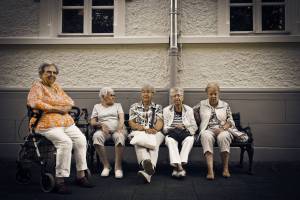 older women sitting on a bench at a retirment home