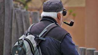 older man smoking a pipe