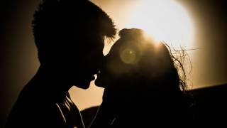 sunset couple kissing