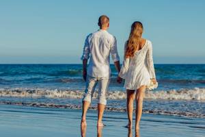 young couple looking at the surf