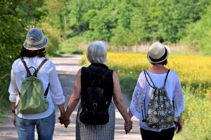 women holding hands looking hopeful