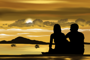 couple silhoutte against the sky and ocean